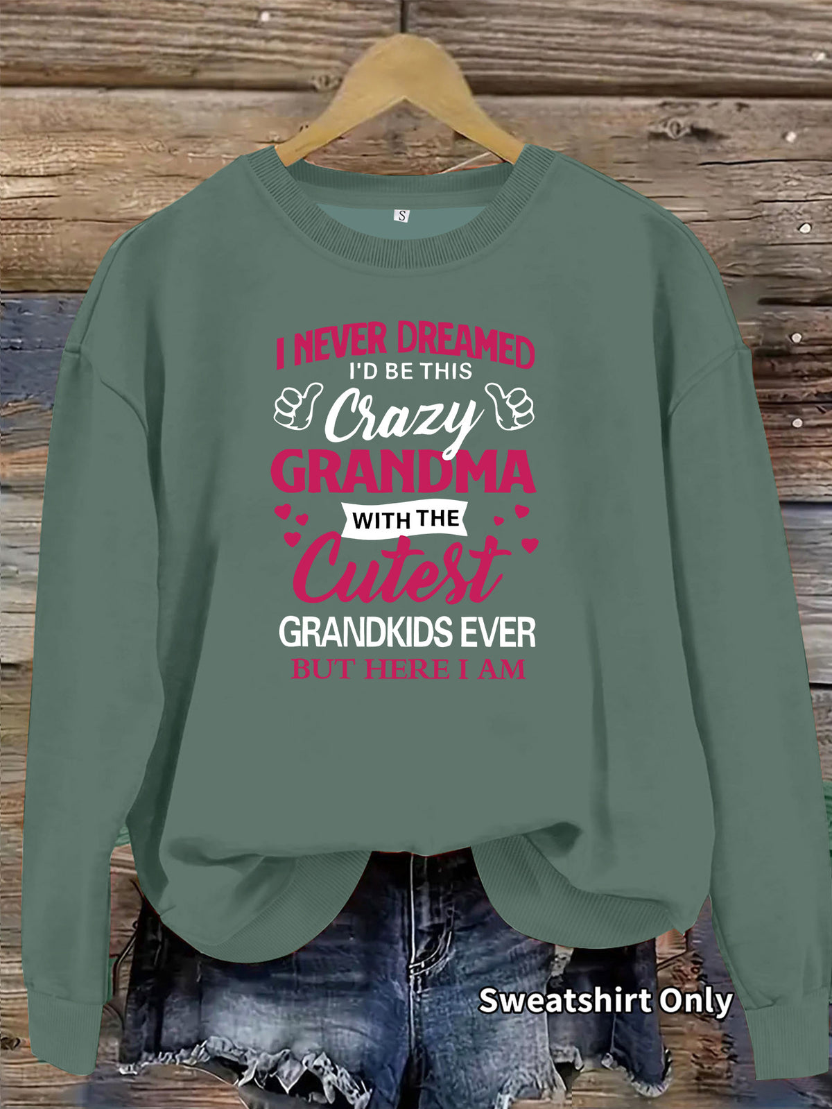 A green crewneck sweatshirt with pink and white text reading "I NEVER DREAMED... CRAZY GRANDMA".