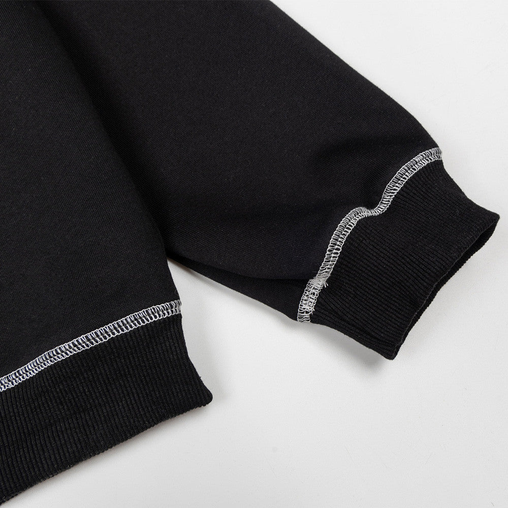 Black cotton sweatshirt with solid pattern, ribbed cuffs, and contrasting white zigzag topstitching.
