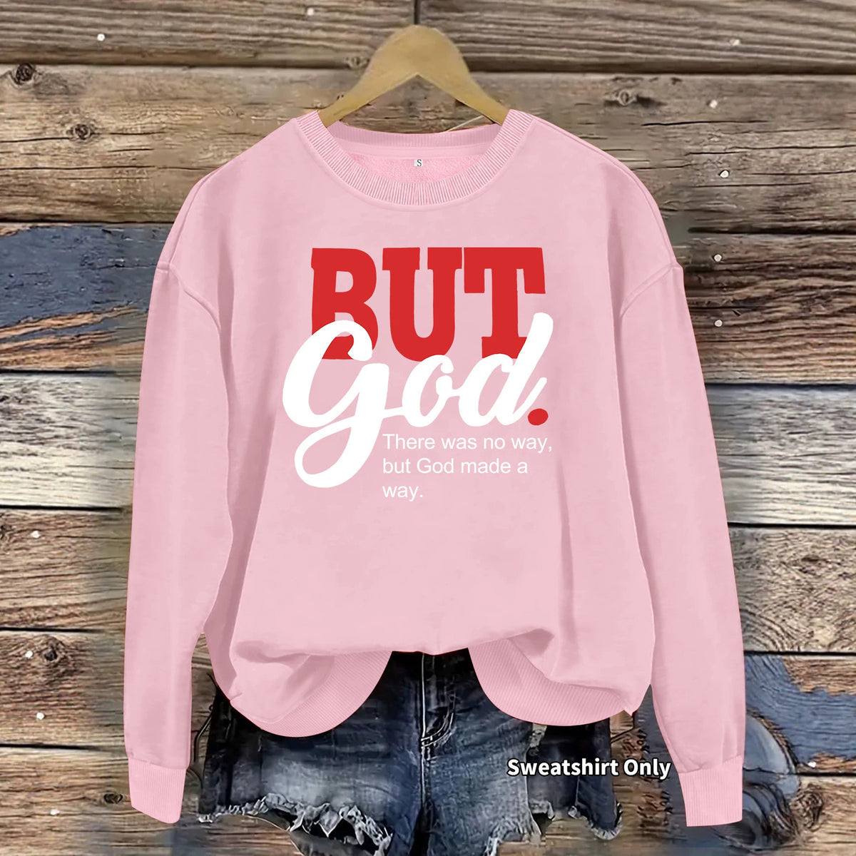 Pink cotton crewneck sweatshirt with red and white text reading "BUT God. There was no way, but God made a way."