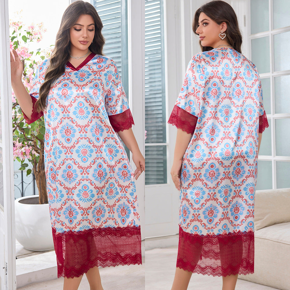 A woman models a long satin nightgown featuring a blue and red damask pattern, V-neck, and red lace trim.