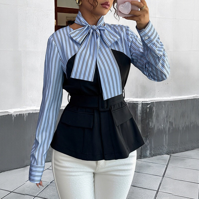 Black and blue striped top with long sleeves, tie neck, belted waist, and flap pockets, paired with white pants.