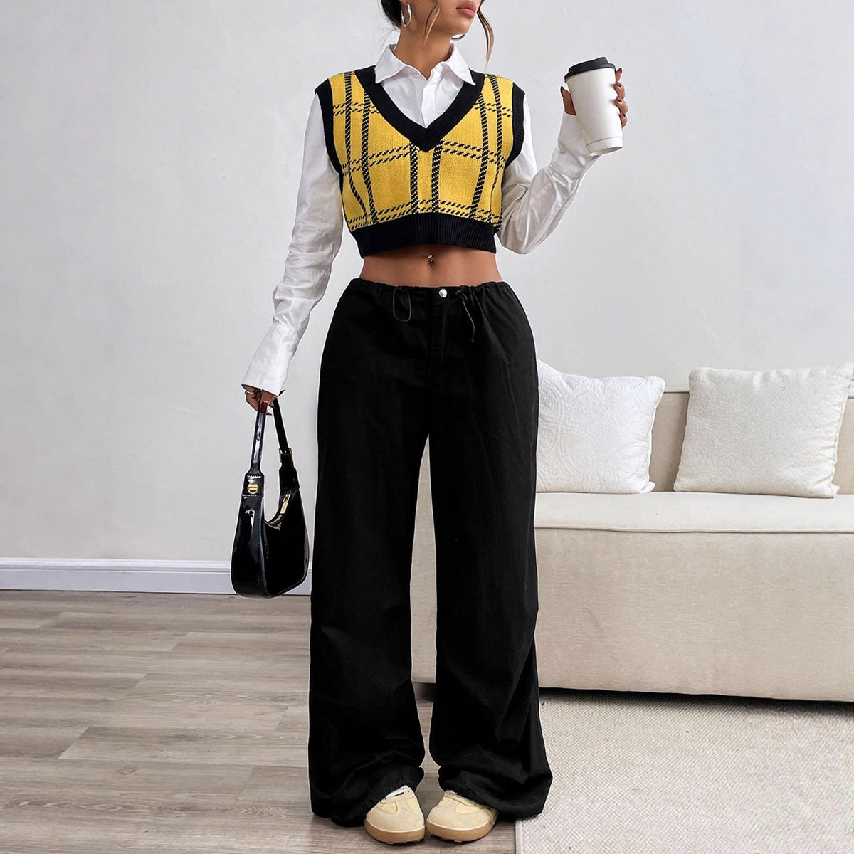 Yellow and black plaid knit cropped sweater vest layered over a white collared shirt.