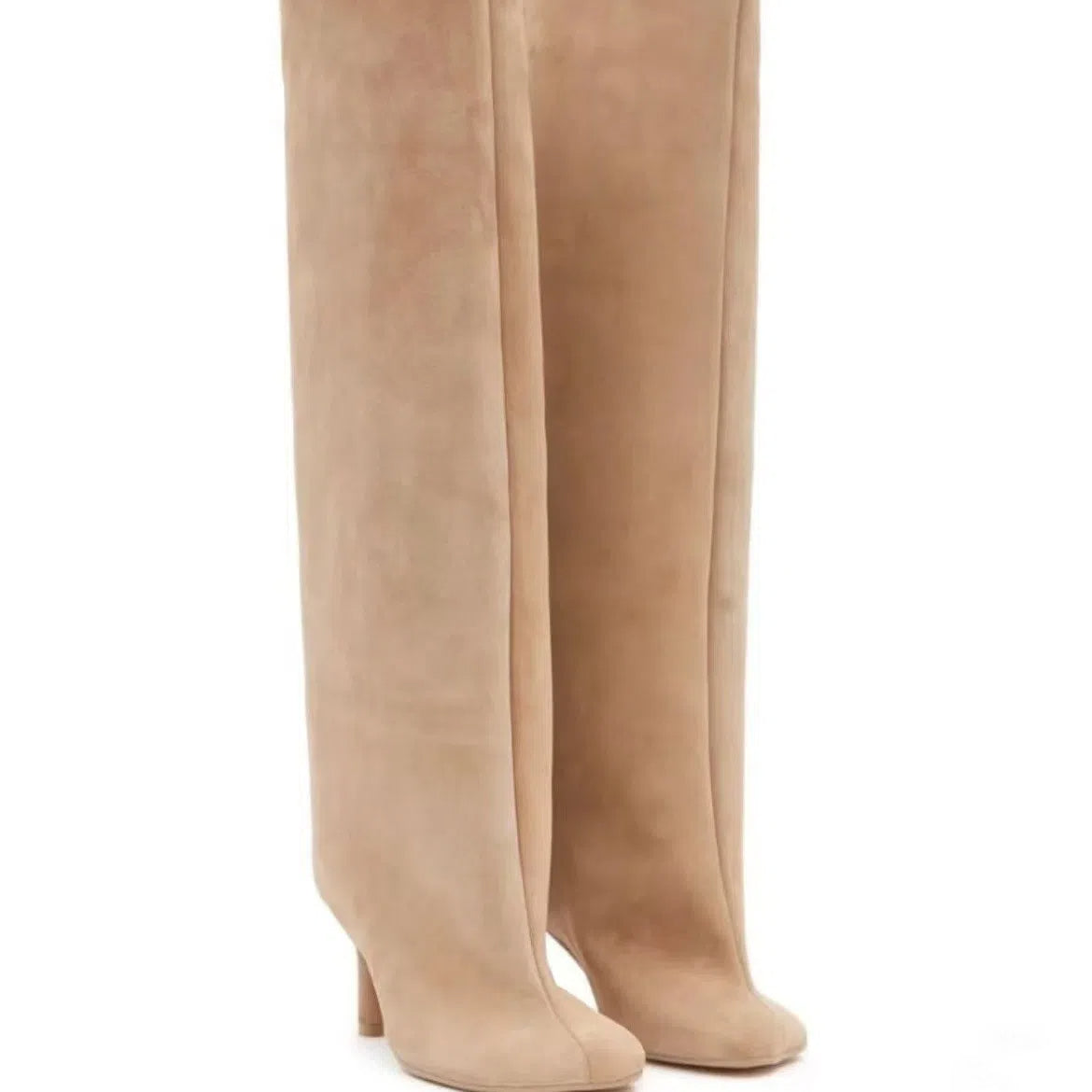 Tan suede over-the-knee boots with slouchy shafts, pointed toes, and thin high heels.
