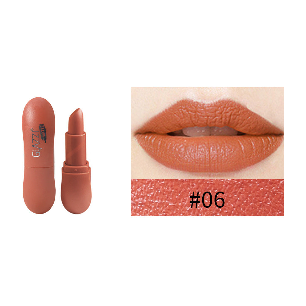 Matte rust-orange lipstick in a rounded plastic case with embossed text, alongside a swatch and lips wearing the shade.
