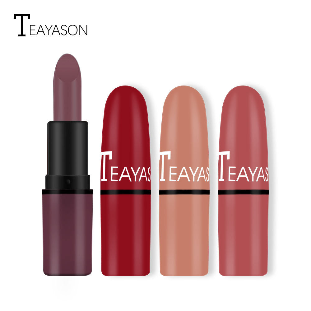 Four Teayason brand lipsticks with black and colored plastic cases in plum, red, nude, and rose, plus one open plum lipstick.