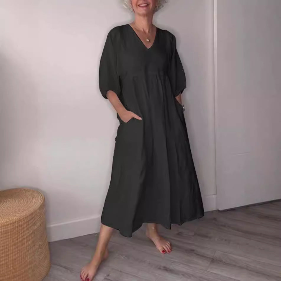 Deep V-neck pleated solid color pocket dress by eprolo, featuring a flattering neckline, pleats, and practical pockets.