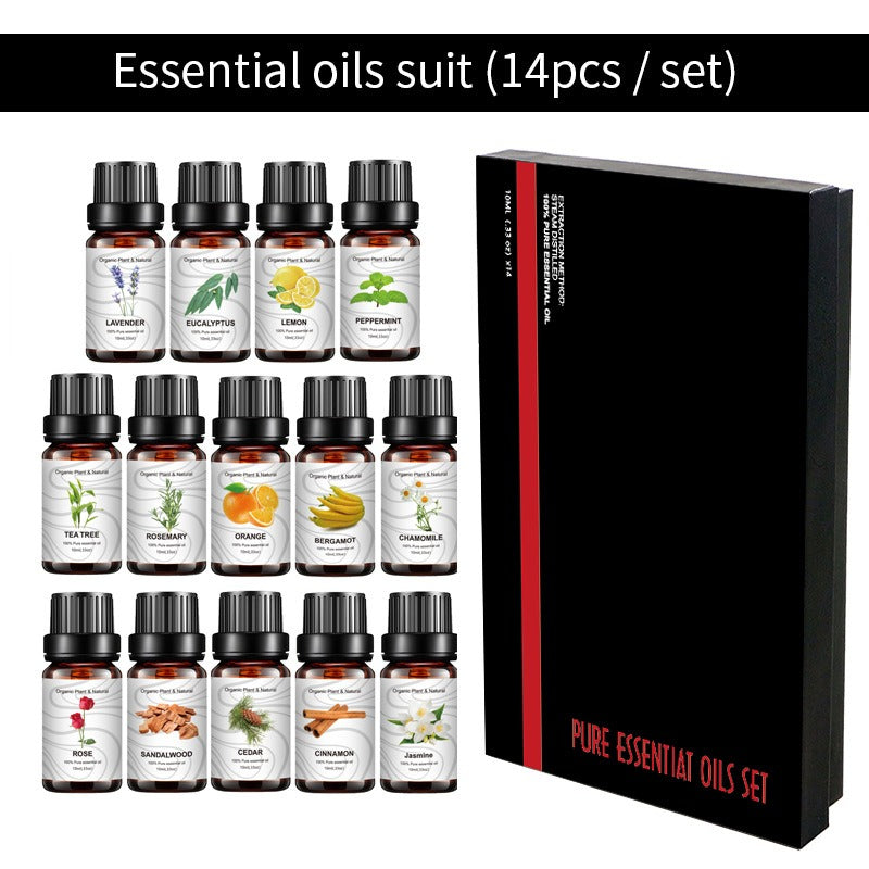 Fourteen amber glass essential oil bottles with black caps, white labels, and a black gift box.