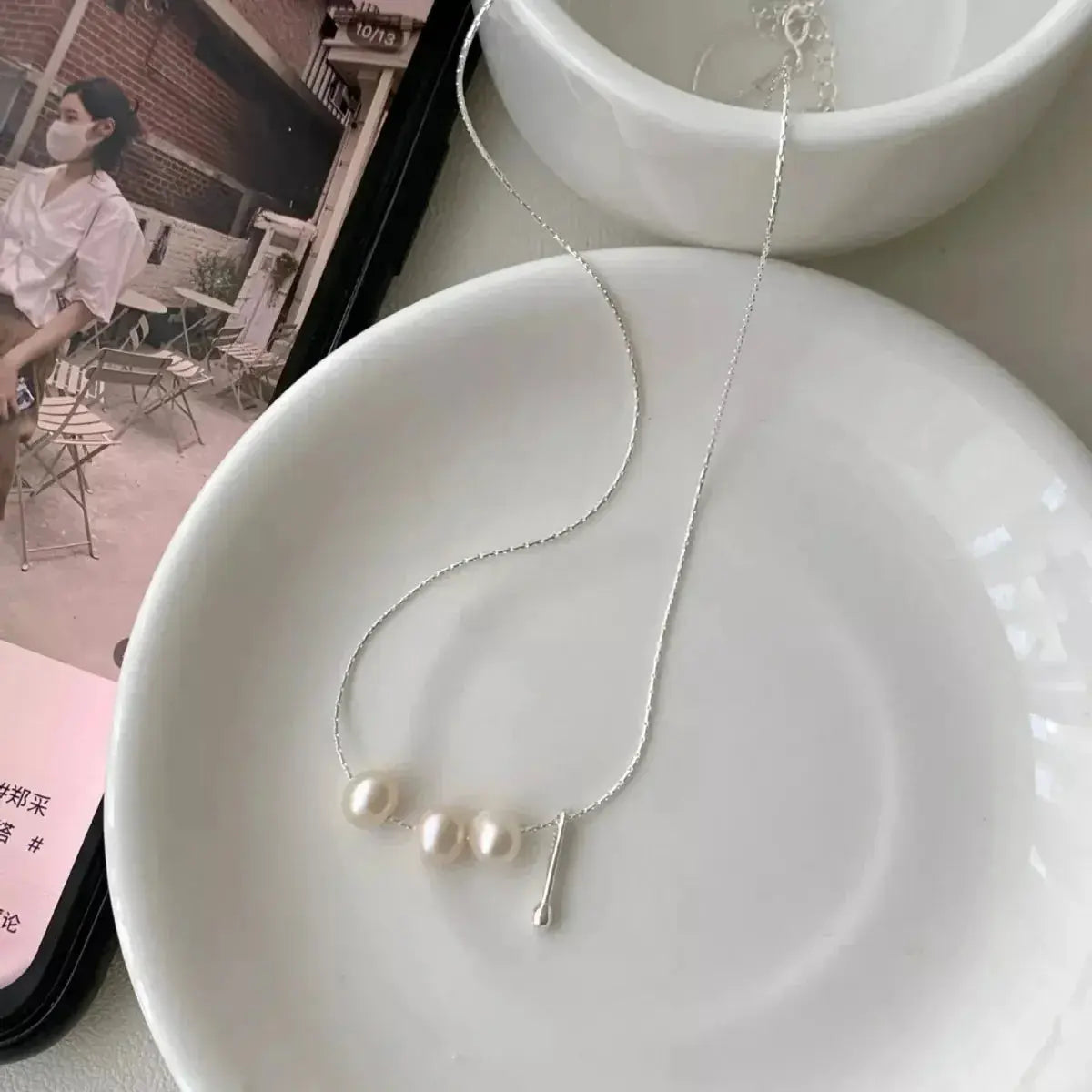 Genuine freshwater pearl and sterling silver pendant necklace with delicate chain, elegant jewelry accessory.
