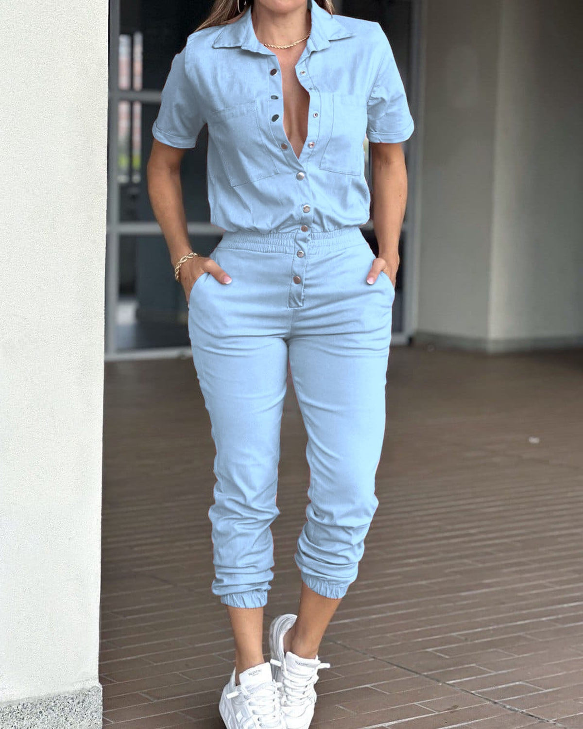 Casual women's ankle-tied jumpsuit with collar, pockets, elastic waist, and button details by Plush Fashion Hub.