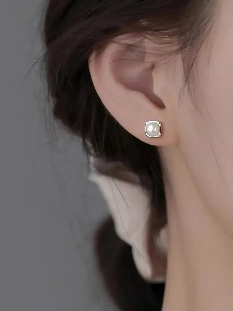 Sterling silver pearl stud earrings featuring minimalist geometric design, elegant jewelry for women by Plush Fashion Hub