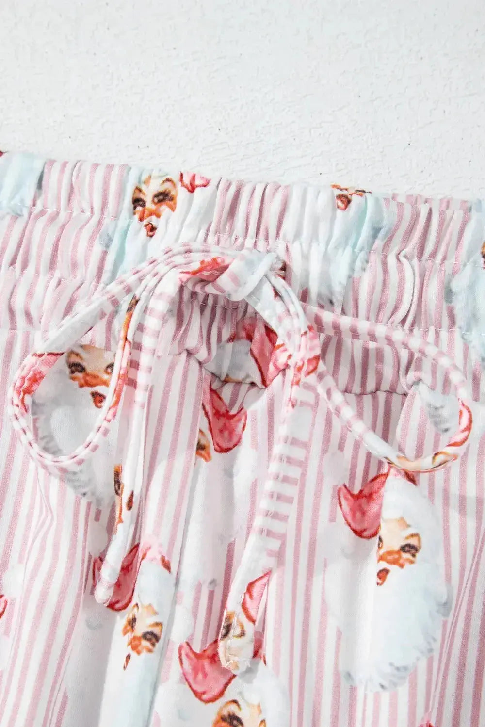 Women's festive Santa print long sleeve pajama lounge set by Plush Fashion Hub, featuring cozy holiday-themed pajamas.