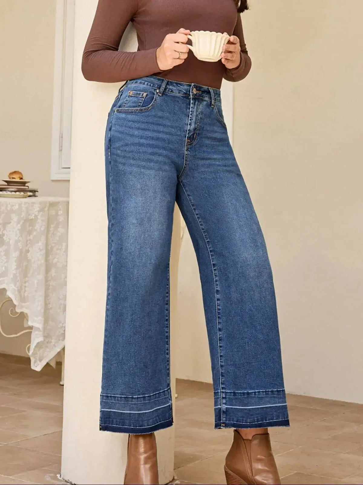 Women’s high-waisted wide-leg washed denim jeans with a relaxed fit, featuring classic styling and visible denim texture.