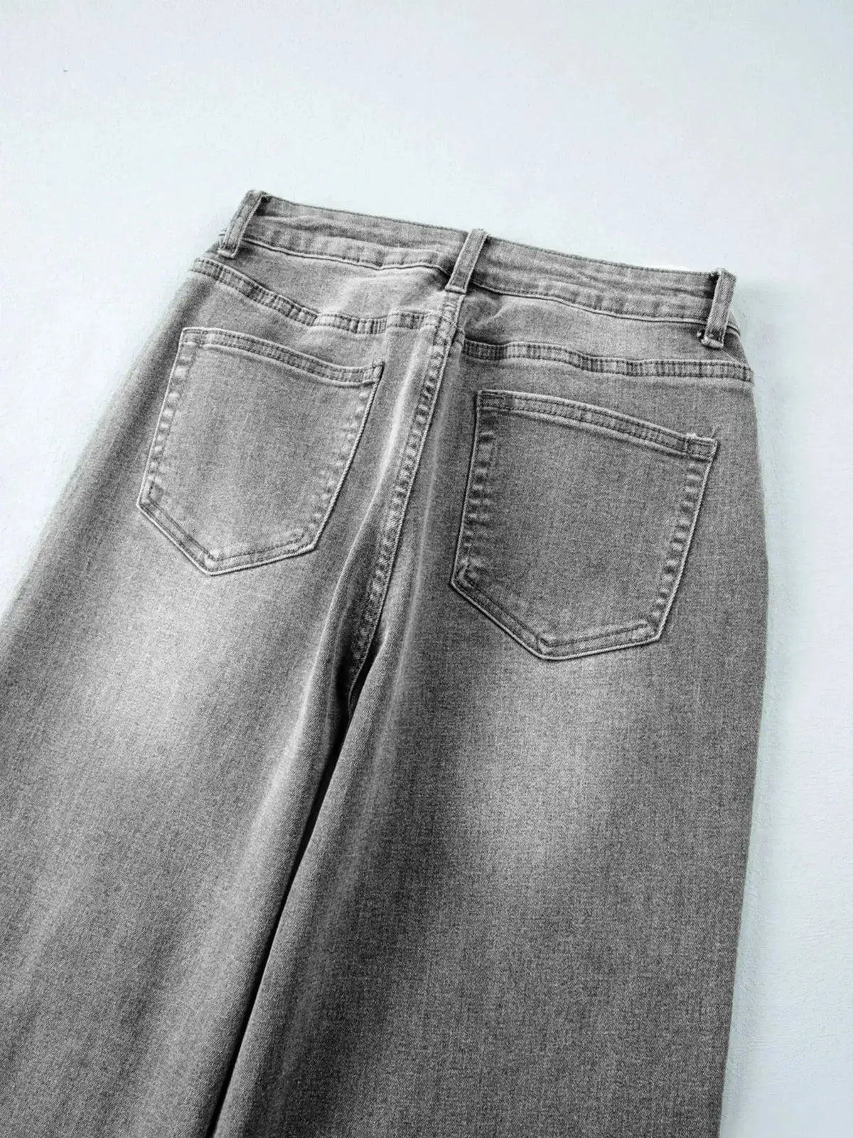 Women’s high-waisted wide-leg washed denim jeans with a classic relaxed fit by Plush Fashion Hub, shown on a model.