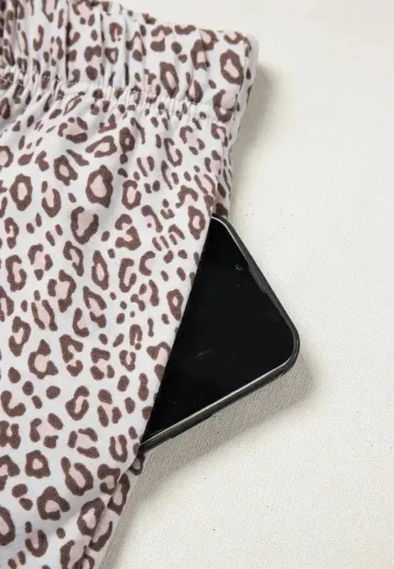Women's leopard print long sleeve pajama lounge set by Plush Fashion Hub, featuring button-down top and comfortable matching pants.