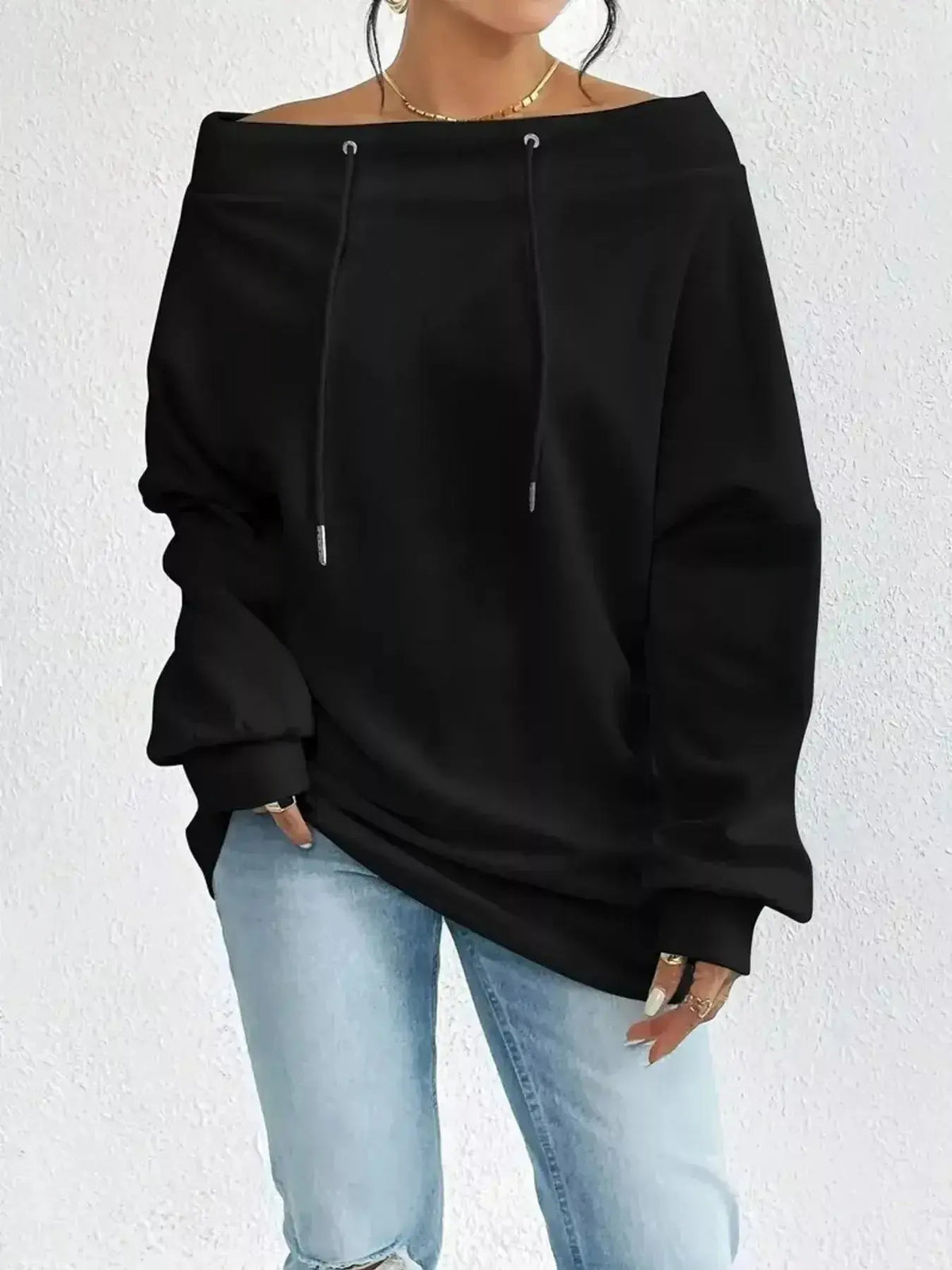 Women wearing a plush brand off-shoulder long sleeve drawstring sweatshirt, casual style with relaxed fit and soft fabric.