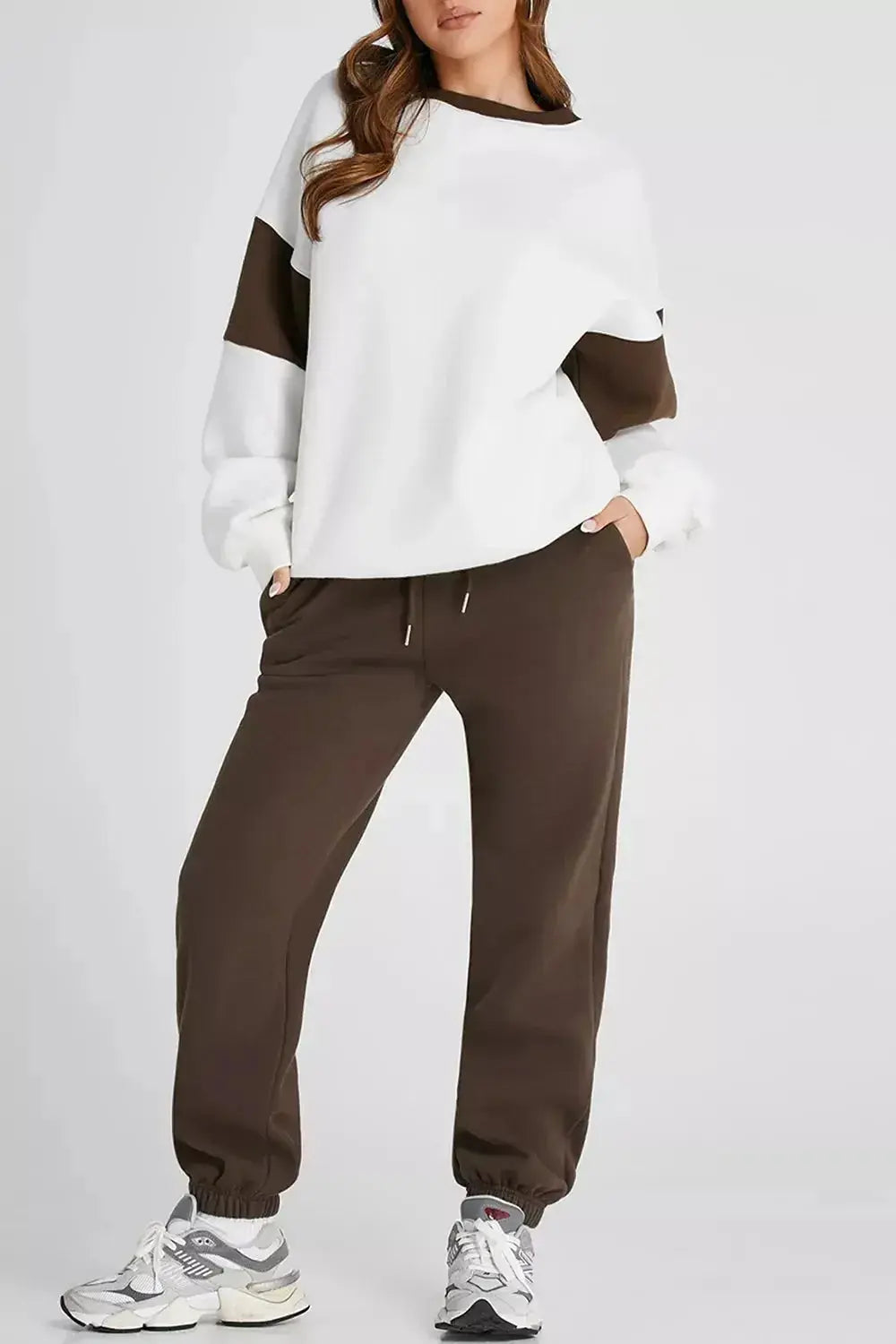 Women wearing Plush Fashion Hub oversized drop shoulder sweatshirt and matching joggers loungewear set, comfortable casual outfit.