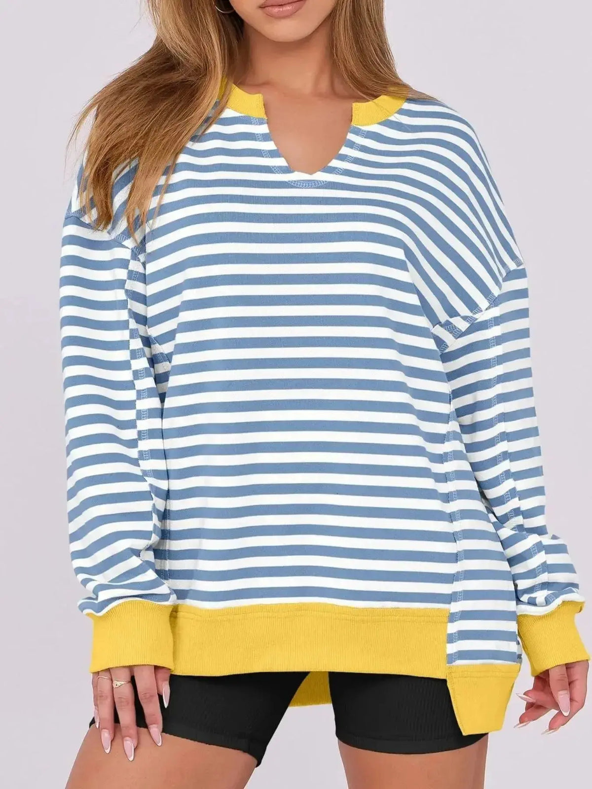 Women’s oversized notched neck sweatshirt with contrast stitching from Plush Fashion Hub, featuring a relaxed fit and stylish detailing.