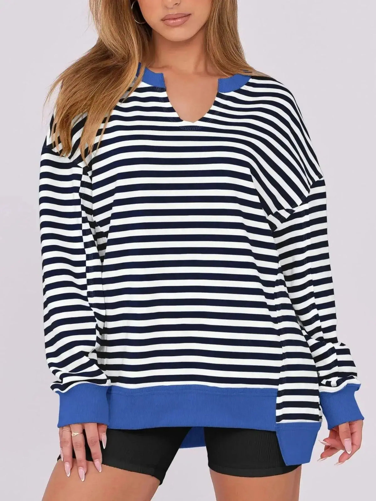 Women’s oversized sweatshirt with notched neckline and contrast stitching from Plush Fashion Hub, featuring a relaxed fit and stylish design.