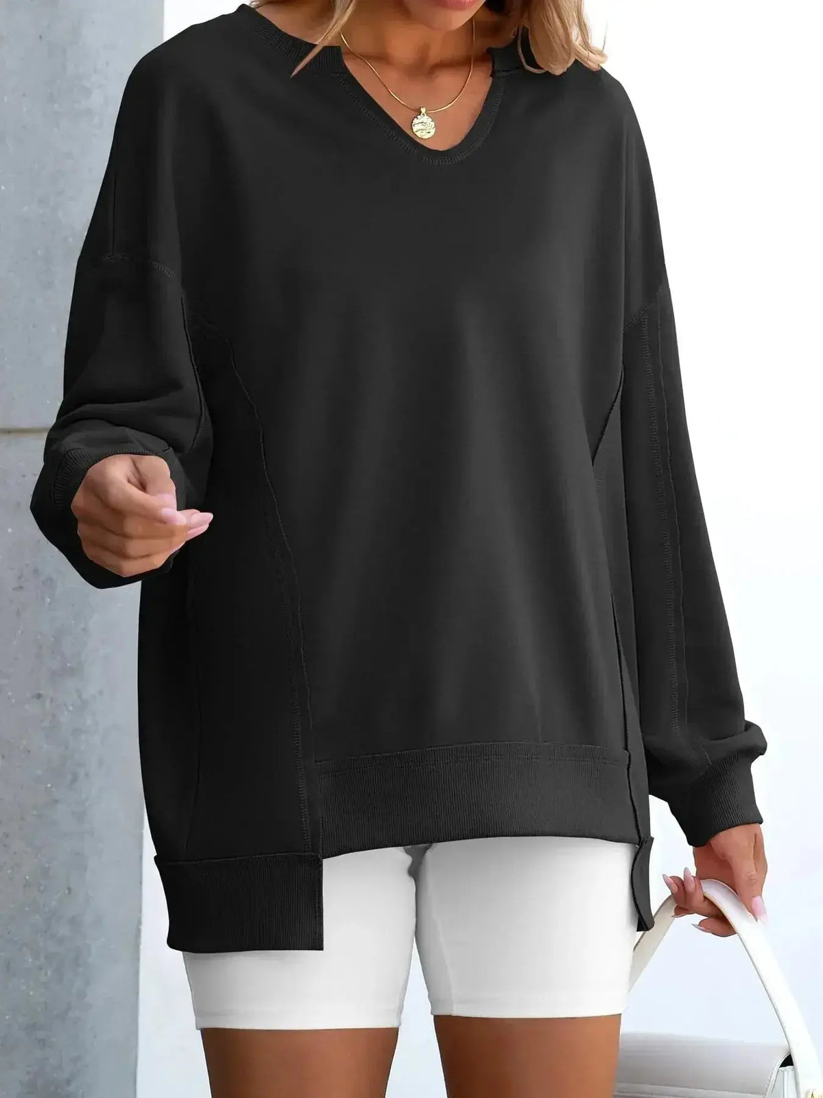 Women’s oversized notched neck sweatshirt with contrast stitching, from Plush Fashion Hub, featuring a relaxed fit and stylish design.