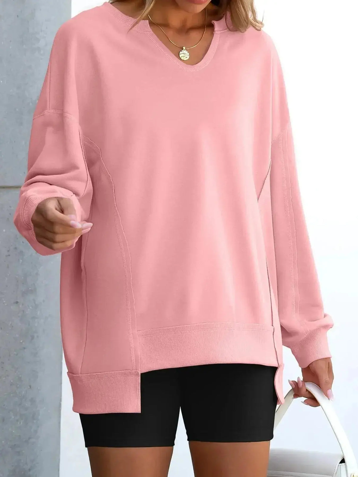 Women’s oversized notched neck sweatshirt with contrast stitching, stylish sweater from Plush Fashion Hub, shown on a model.