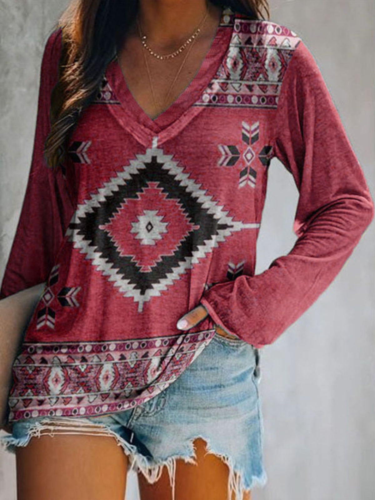 Plus size V-neck long sleeve T-shirt with geometric print by Plush Fashion Hub, casual top, shown in a relaxed fit image.