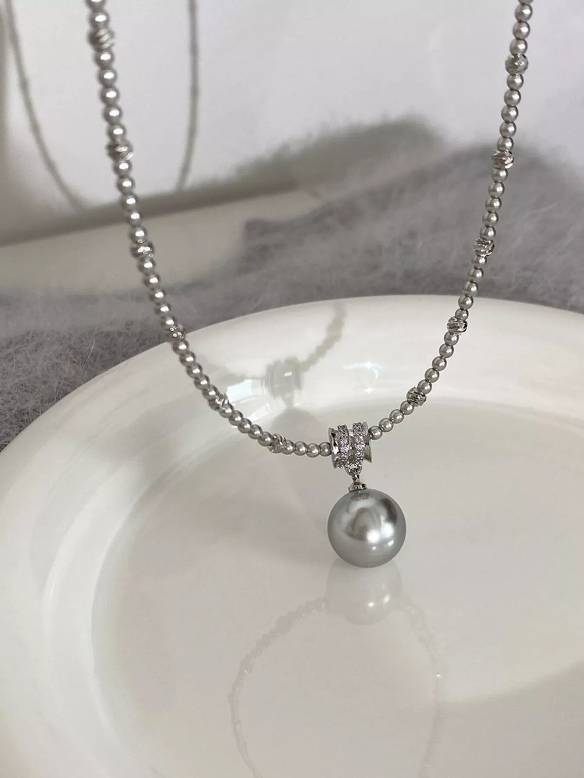 Elegant pearl pendant necklace from Plush Fashion Hub featuring a classic white pearl on a delicate chain.