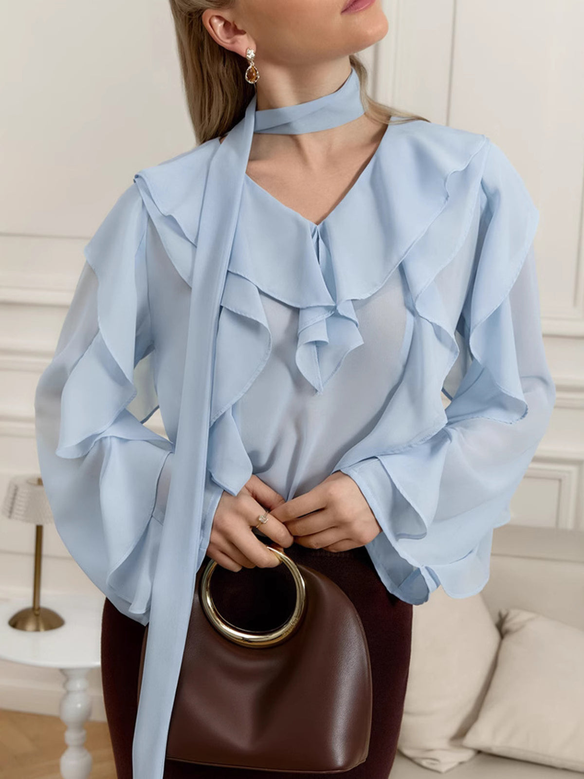 Elegant chiffon blouse with ruffle trim and tie neck by Plush Fashion Hub, featuring a flowy fabric and stylish design.