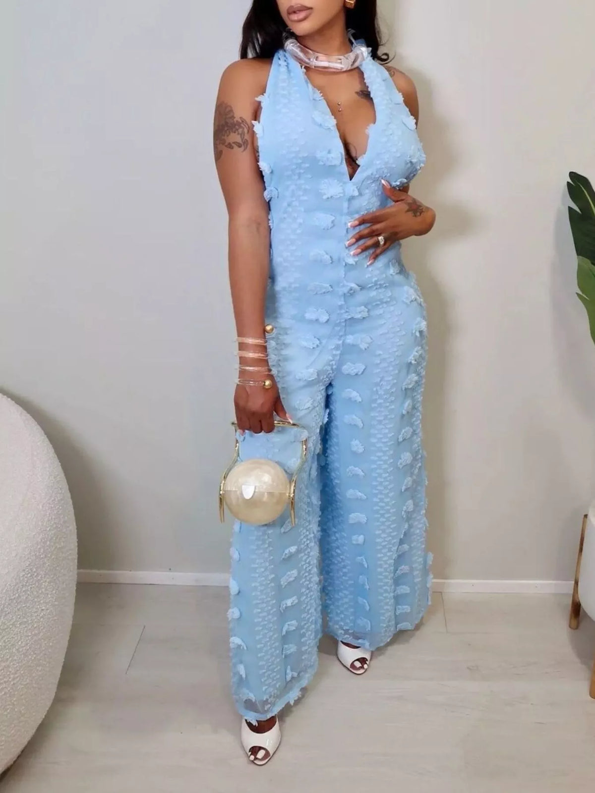 Textured halter wide-leg jumpsuit for women by Trendsi, featuring a stylish design and comfortable fit, shown on a model.