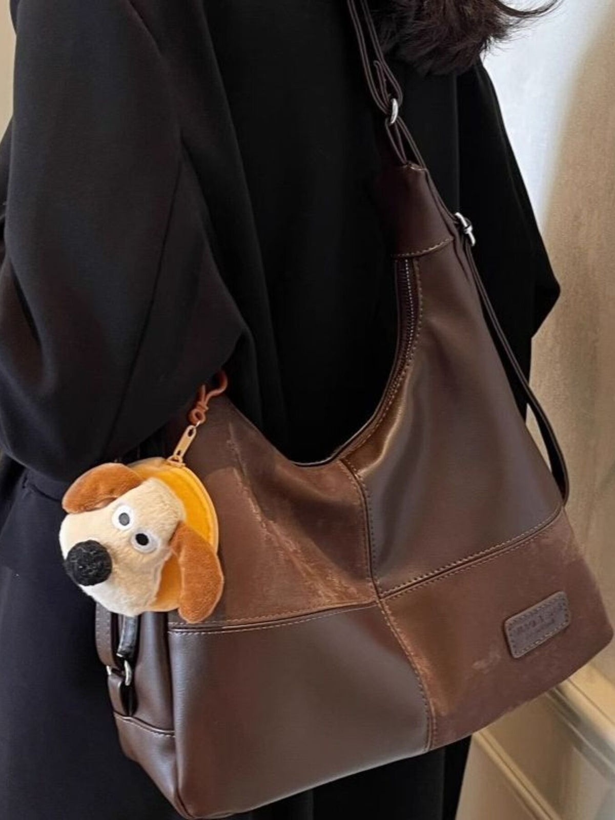 Vintage-inspired plush leather slouchy hobo shoulder bag with spacious design and stylish accents, perfect for casual and chic look.