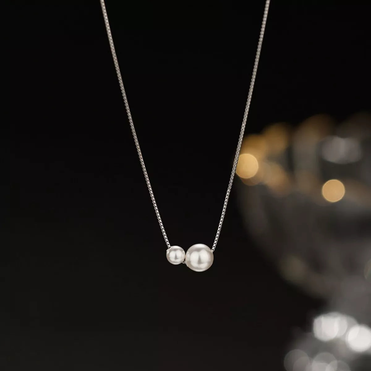 Sterling silver pearl necklace featuring lustrous white pearls and delicate chain design, crafted by Plush Fashion Hub.