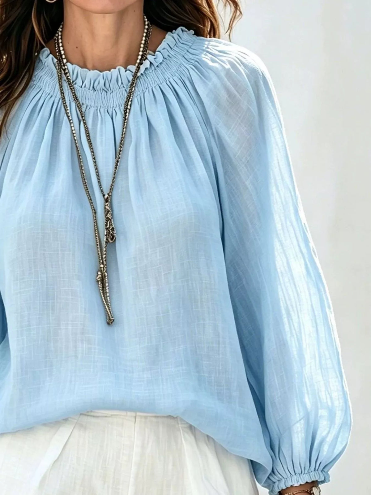 Women’s round neck balloon sleeve blouse by Trendsi, featuring a stylish fit and soft fabric, shown on a model.