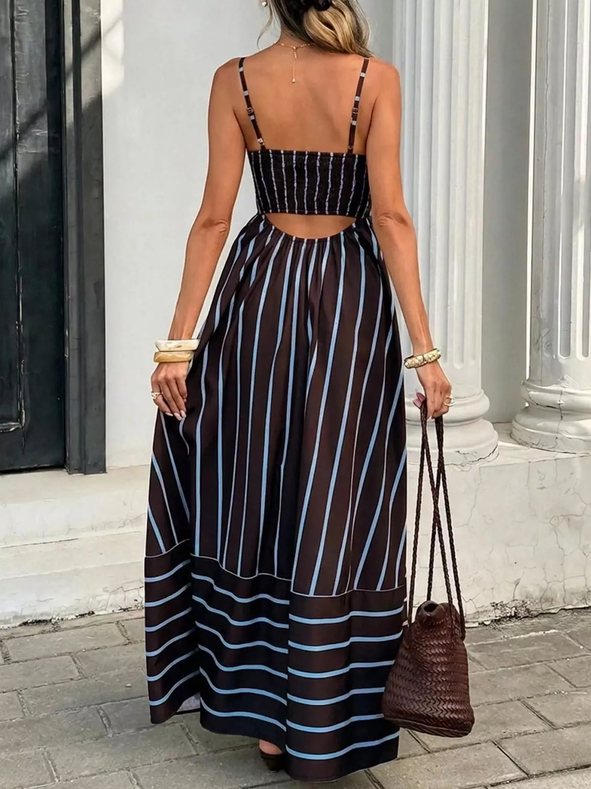 Striped cutout back maxi dress by Plush Fashion Hub featuring a flowy silhouette and bold stripe pattern.