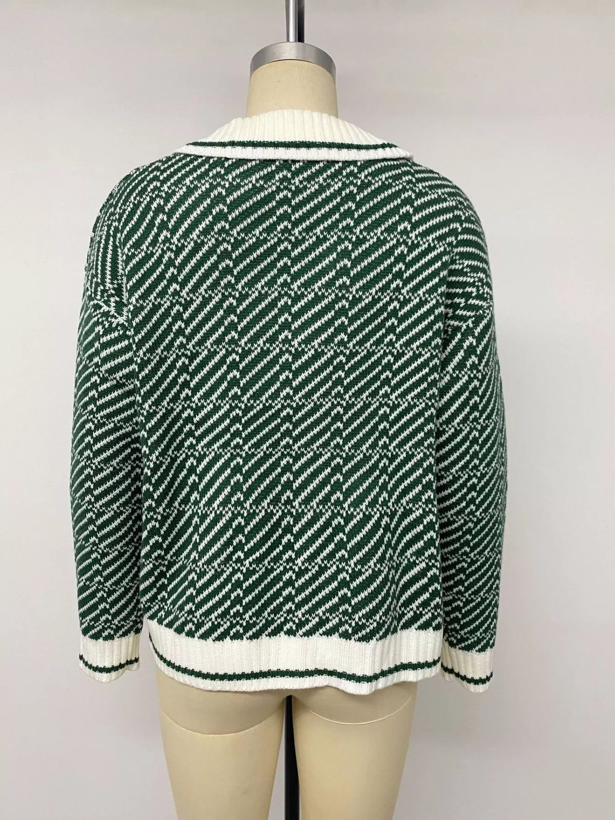 Plush Fashion Hub geometric patterned collared sweater with bold design and ribbed cuffs, displayed on a mannequin.