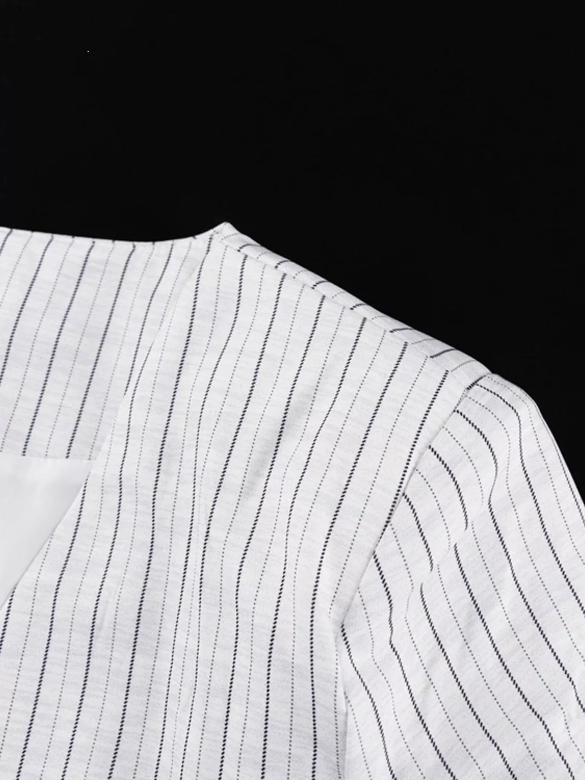 Pinstripe cropped blazer and pleated shorts set by Trendsi, styled together, showcasing tailored fit and lightweight fabric.
