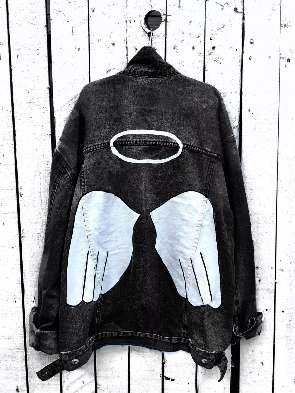 Plus size denim jacket with angel wings graphic back design, trendy full-size Trendsi denim outerwear for a stylish look.