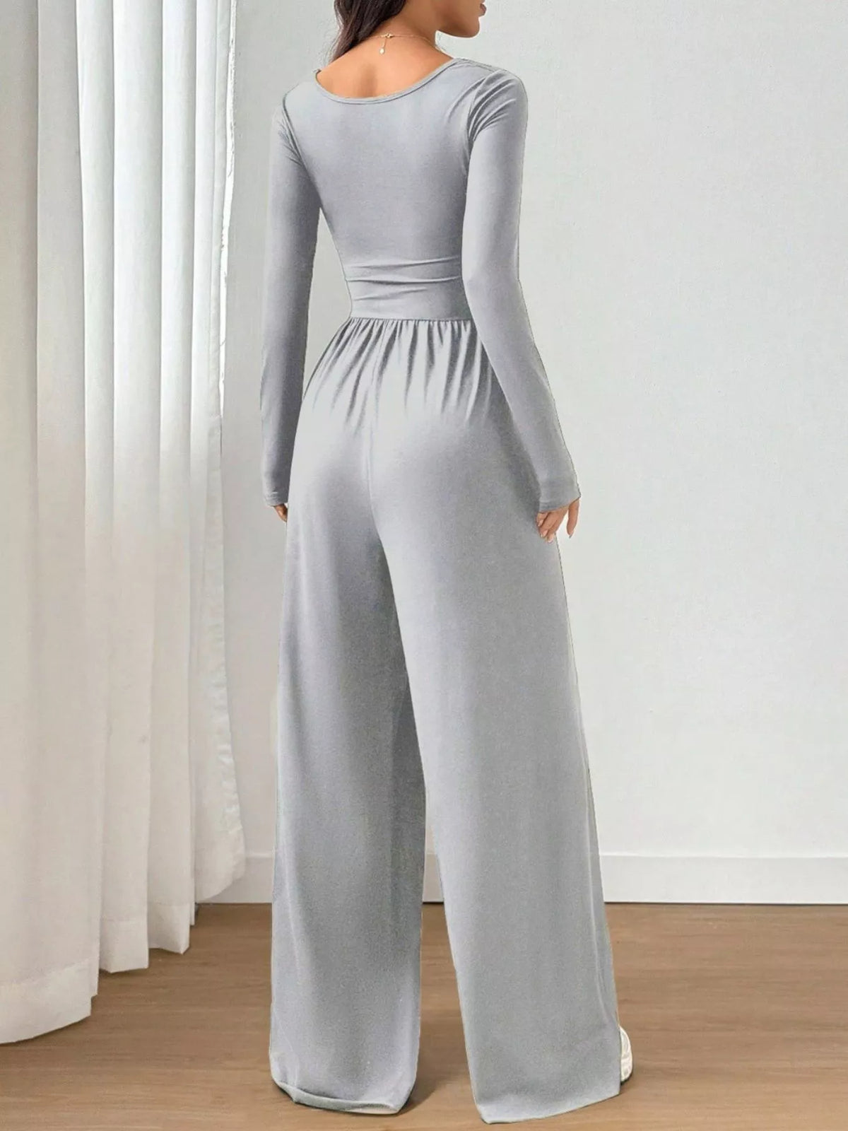 Ruched square neck wide-leg jumpsuit by Trendsi, featuring a stylish fit and elegant design, shown on a model.