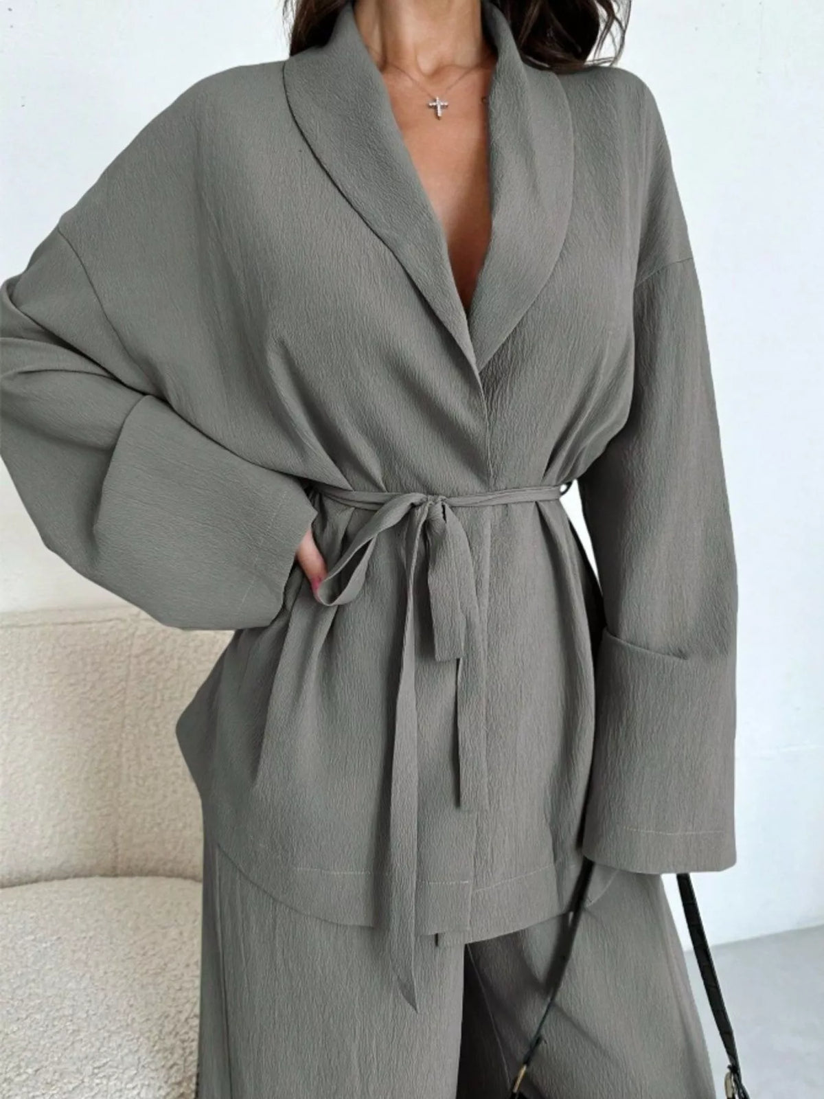 Textured tie waist top and wide-leg pants set for women, stylish fashion ensemble from Trendsi, shown on a model.