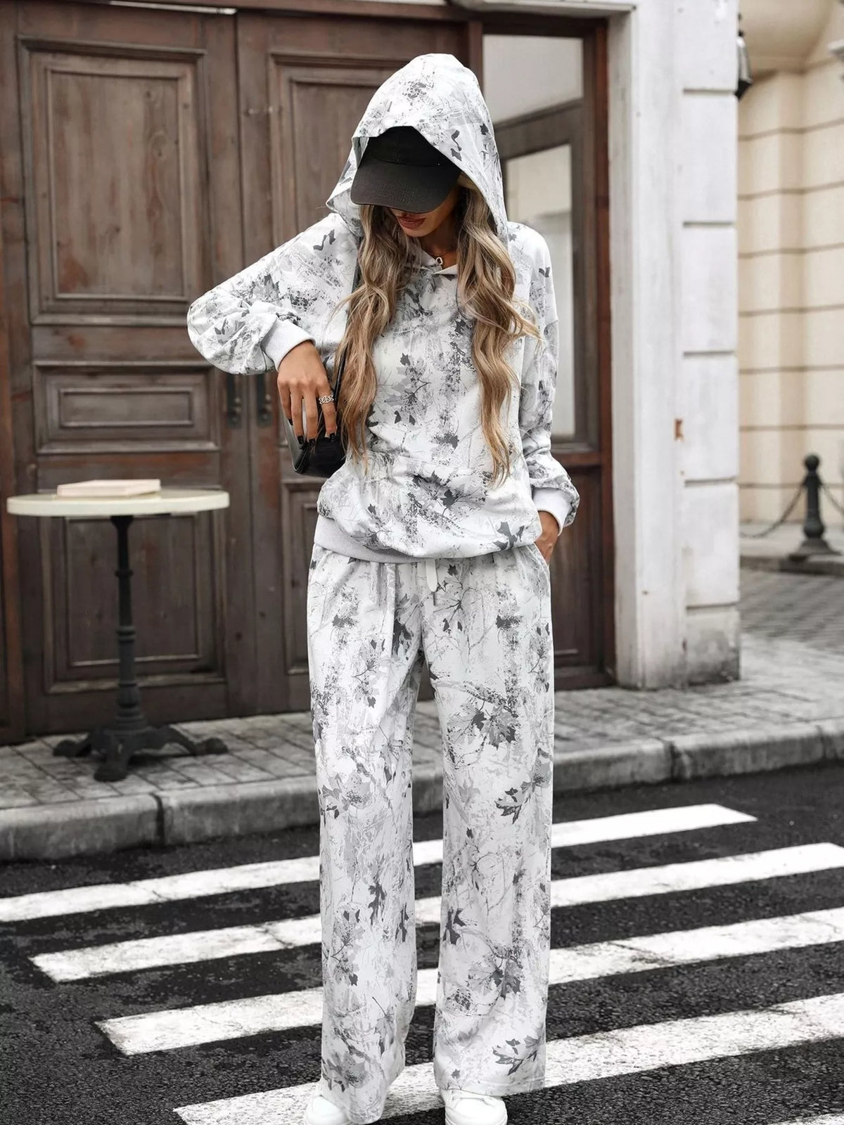 Printed long sleeve hoodie and pants set by Trendsi featuring a comfortable, stylish matching outfit for casual wear.