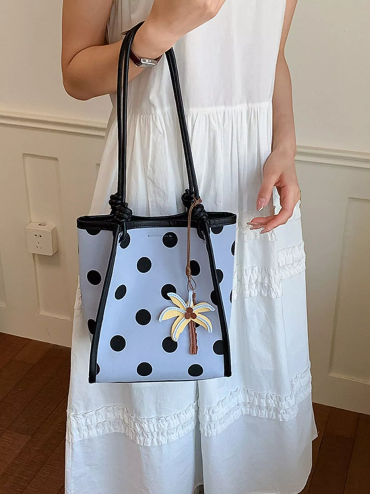 Polka dot shoulder handbag from Plush Fashion Hub featuring a stylish design with a top handle and adjustable shoulder strap.
