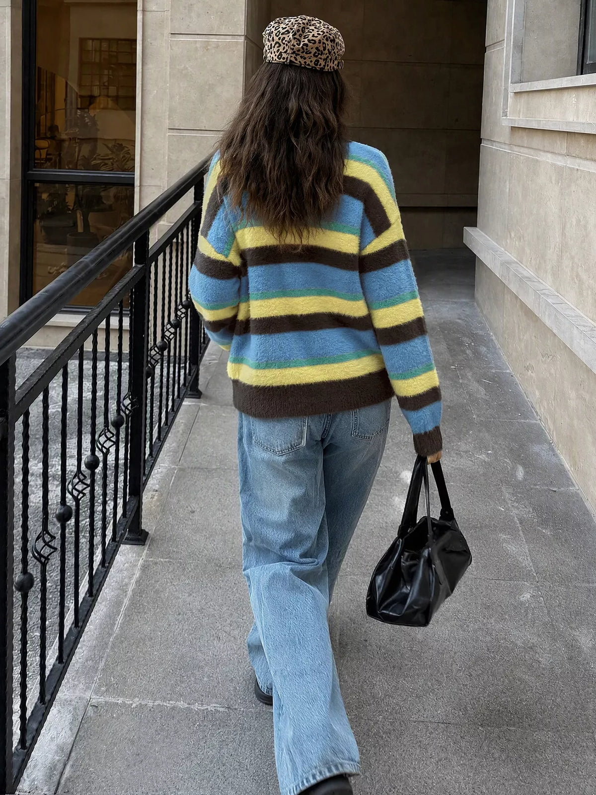 Striped dropped shoulder sweater by Trendsi, featuring a cozy knit design with horizontal stripes and a relaxed fit.