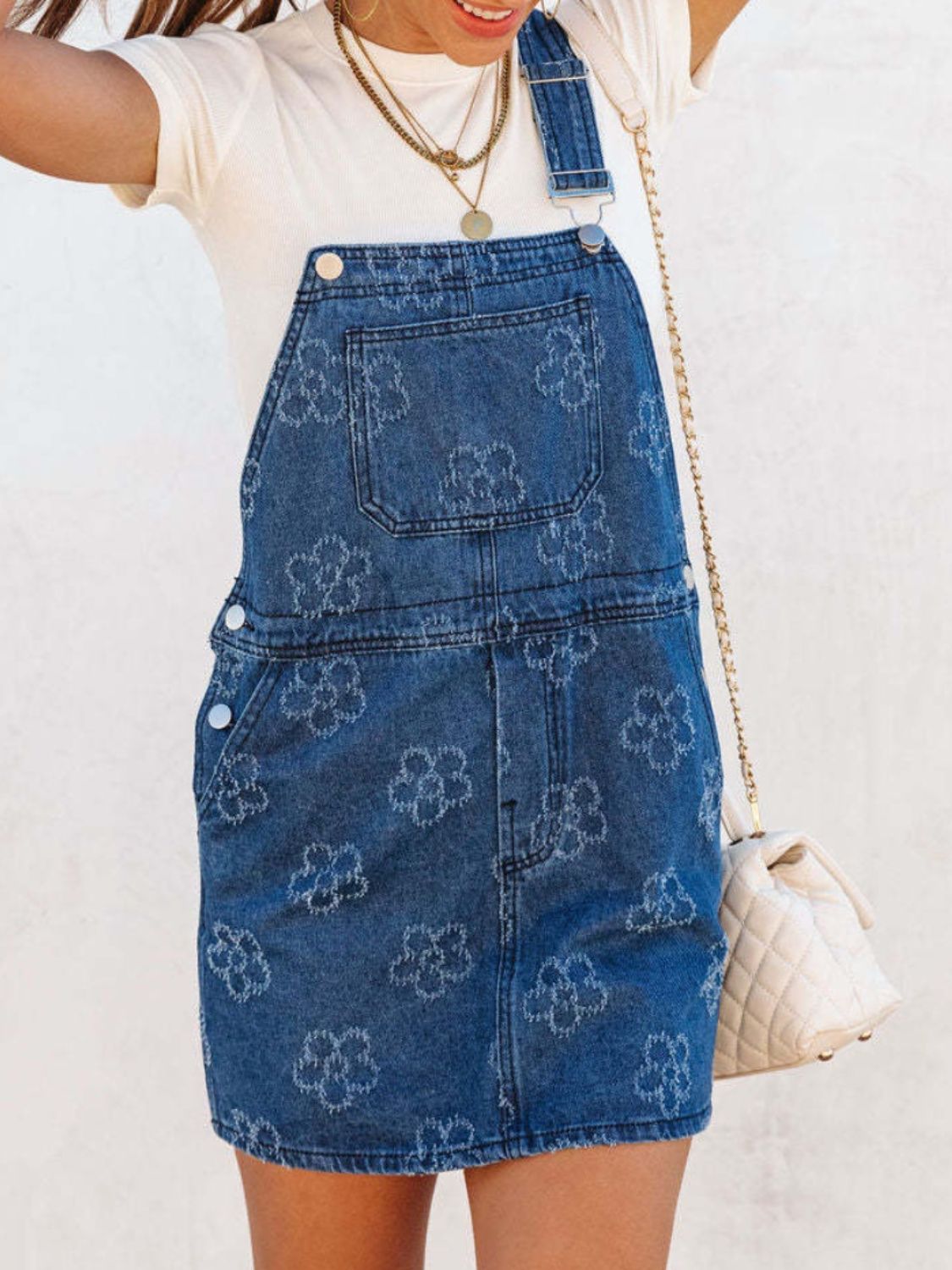 Flower wide strap denim overall dress with pockets from Plush Fashion Hub, shown on a model with a casual, stylish look.