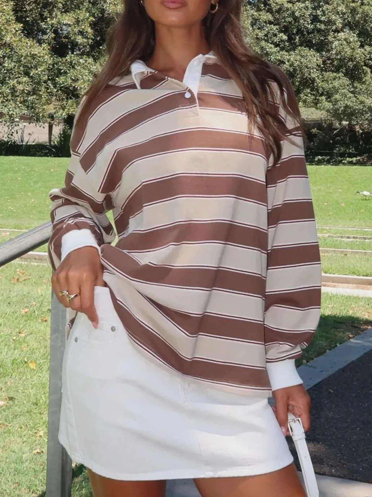 Striped long sleeve polo shirt with button details from Plush Fashion Hub, featuring a classic design and comfortable fit.