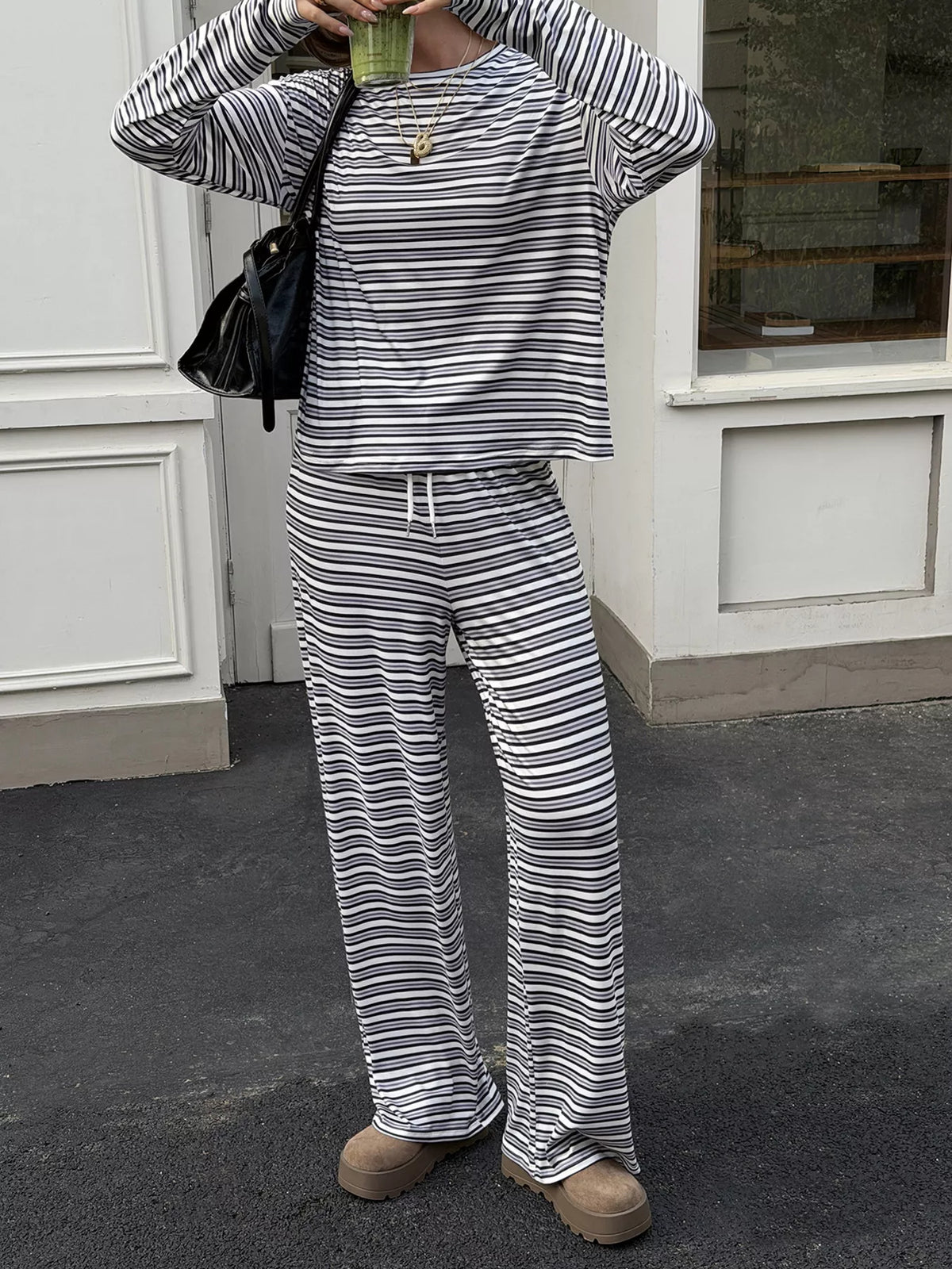 Women’s striped casual long sleeve top and wide-leg pants set by Trendsi, featuring stylish proportions and comfortable fabric.