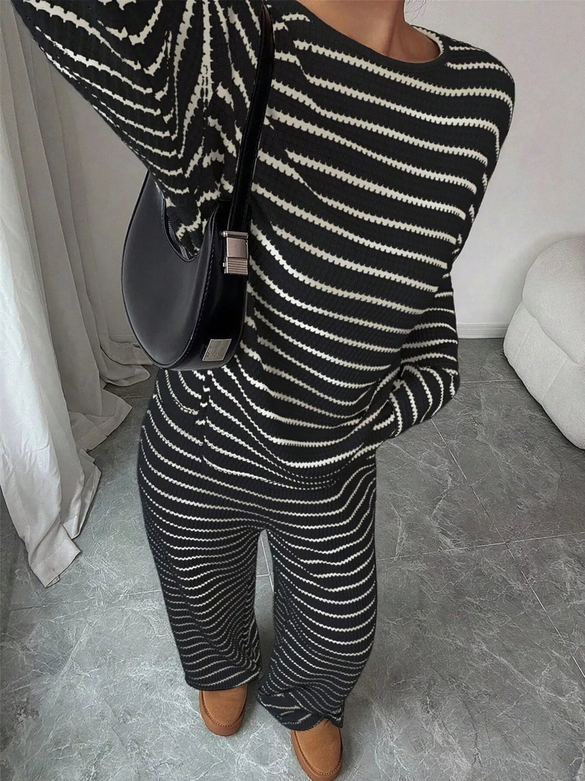 Striped knit dropped shoulder top and pants set by Trendsi, featuring cozy fabric and relaxed fit in a stylish design.