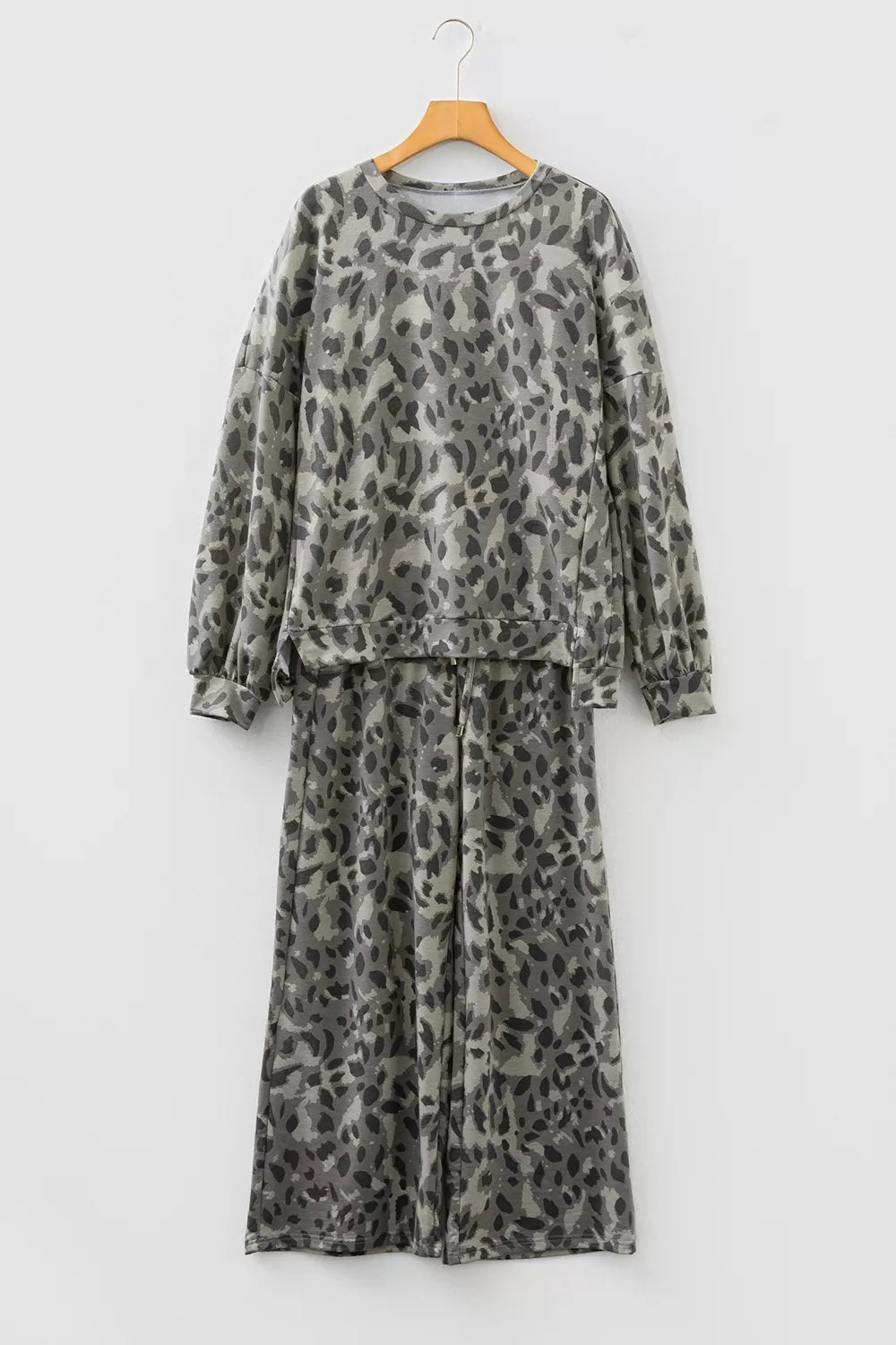 Leopard print long sleeve top and matching pants set by Trendsi, featuring a stylish animal print design.