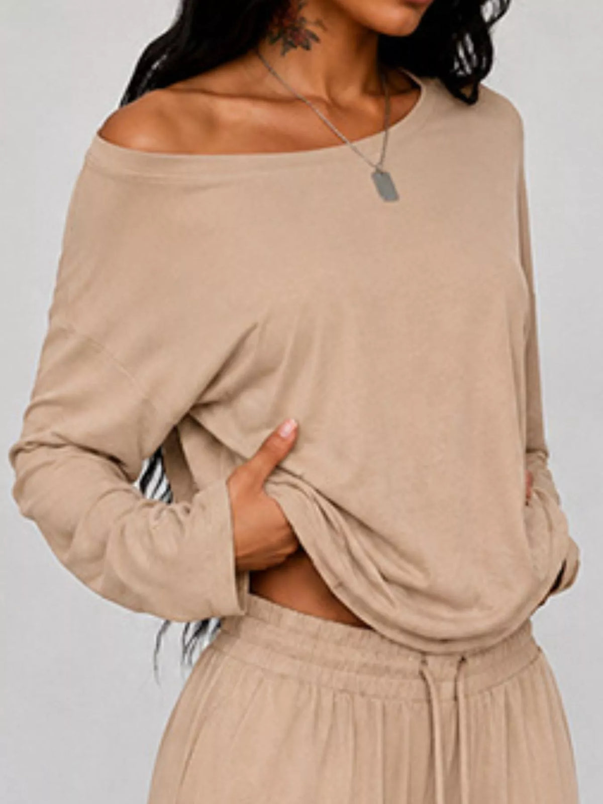 Plus size one-shoulder top and drawstring pants set from Trendsi, stylish matching outfit with a modern, comfortable fit.