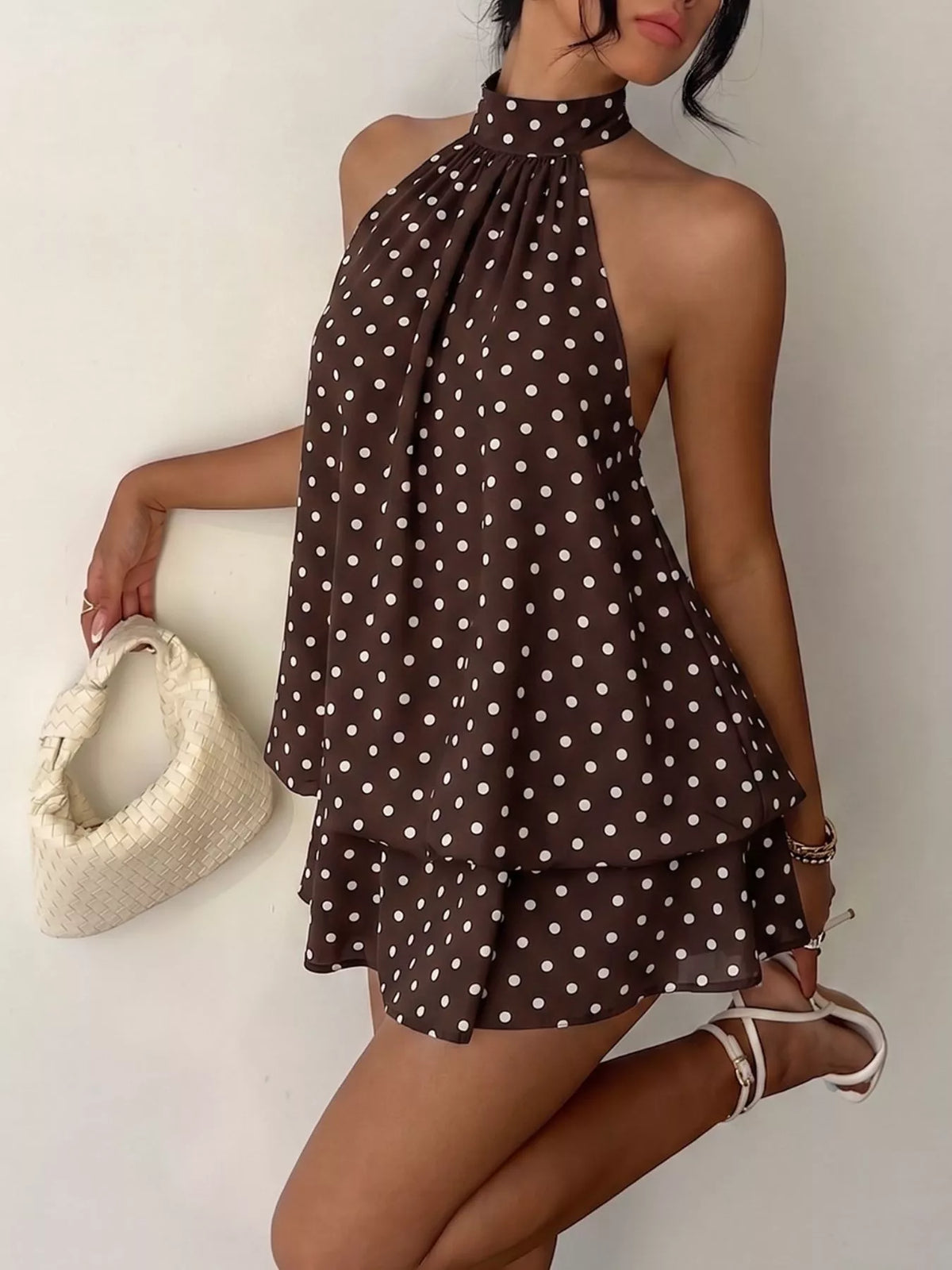 Polka dot halter neck mini dress by Plush Fashion Hub featuring a fitted silhouette and stylish design.