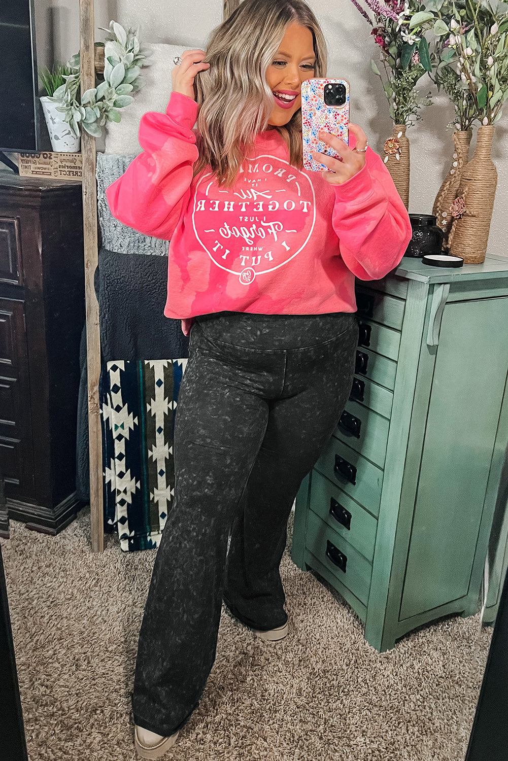 A plus-size woman wears gray high-waist slim-fit flare pants with a mineral wash finish.