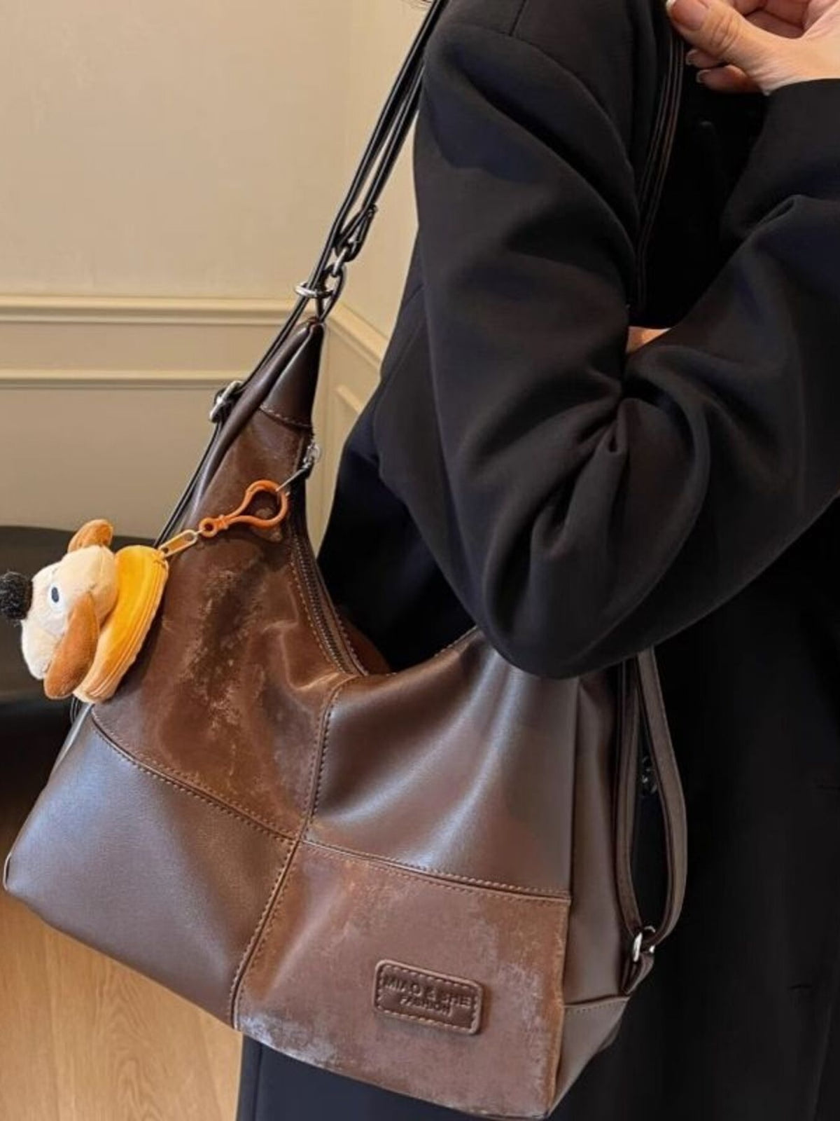 Vintage-inspired plush leather hobo shoulder bag with slouchy design, featuring soft PU leather and spacious interior.