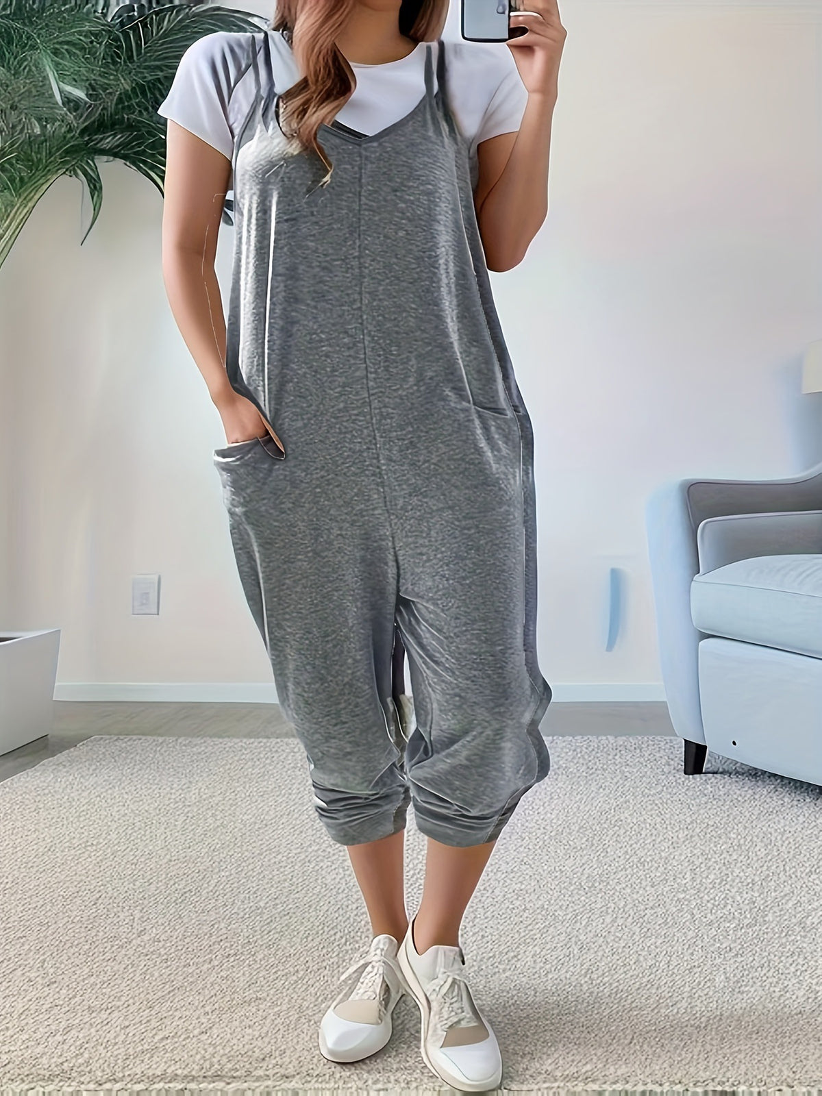 Casual loose-fit spaghetti strap jumpsuit with pockets from Plush Fashion Hub, featuring a relaxed style and lightweight fabric.